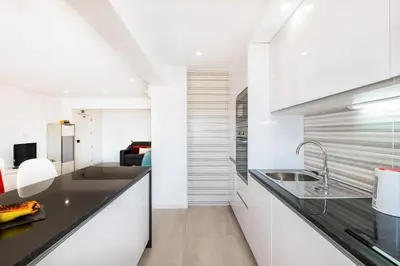 a kitchen with white cabinets and a sink at Apartment Brisbane by Algarve Vacation in Albufeira