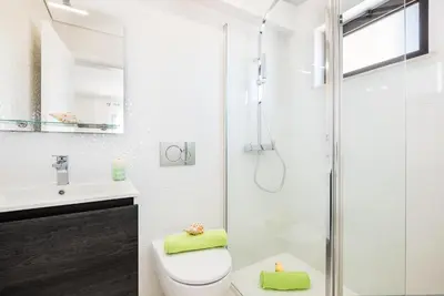a bathroom with a shower and a toilet and a sink at Apartment Brisbane by Algarve Vacation in Albufeira