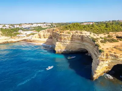 an aerial view of boats in the water next to a large cliff at Apartment Brisbane by Algarve Vacation in Albufeira