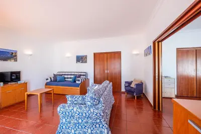 a living room with a bed and a couch at Villa Bermudas by Algarve Vacation in Albufeira