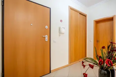 a hallway with a door and a vase of flowers at SeaViewSunset - Encosta da Orada in Albufeira