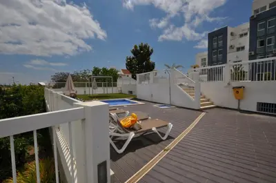 a deck with a hammock on top of a house at Coração do Mar by OCvillas in Albufeira
