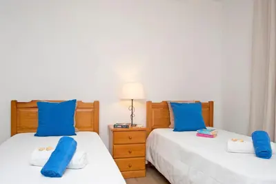 two beds in a bedroom with blue pillows on them at Villa Hollywood by Algarve Vacation in Albufeira