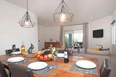 a dining room with a table with a bowl of fruit at Villa Hollywood by Algarve Vacation in Albufeira