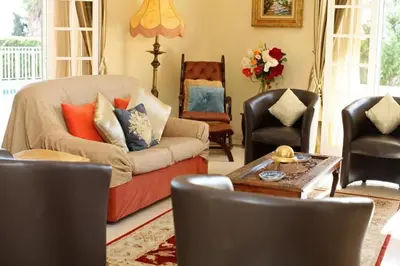 a living room with a couch and chairs and a table at Villa Juniper fenced pool spacious house in Albufeira