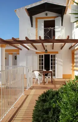 a patio with a table and chairs on a house at Villa Juniper fenced pool spacious house in Albufeira
