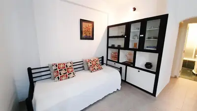 a bedroom with a bed and a black book shelf at Apartamento Kaya by Sunnyway in Albufeira