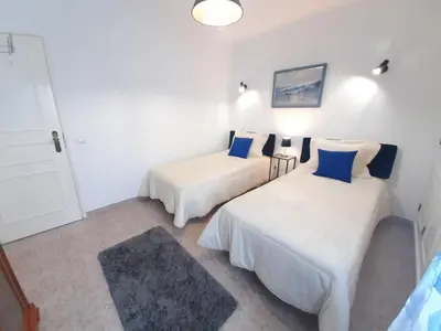 a room with two beds with blue pillows at Apartamento Kaya by Sunnyway in Albufeira