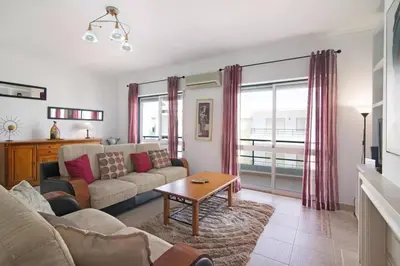 a living room with a couch and a table at Apartamento Kaya by Sunnyway in Albufeira