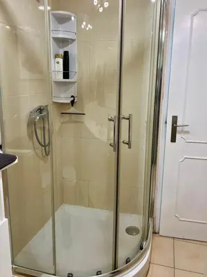 a shower with a glass door in a bathroom at Appartement vista Mar Quarteira in Quarteira