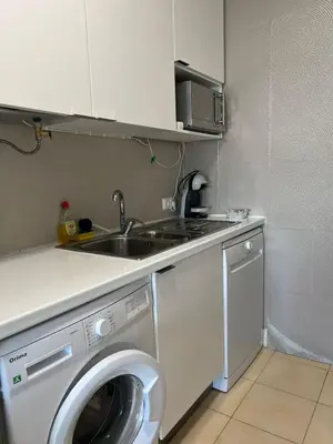 a kitchen with a washing machine and a sink at Appartement vista Mar Quarteira in Quarteira