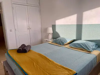 a bedroom with a bed with towels on it at Appartement vista Mar Quarteira in Quarteira