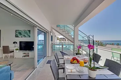 a dining room with a view of the ocean at Ocean Chic by the Beach in Albufeira