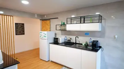 a kitchen with a sink and a refrigerator at BENAMAR HOUSE in Quarteira