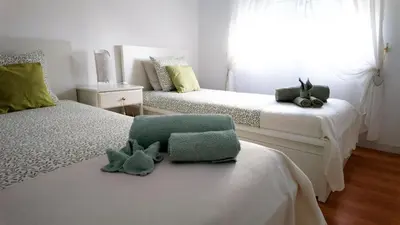 a bedroom with two beds with stuffed animals on them at BENAMAR HOUSE in Quarteira