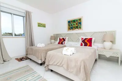 a bedroom with two beds and a window at Apartamento Luna - Golf View By Dalma Portuguesa in Albufeira