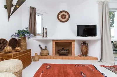 a living room with a fireplace and a tv at Apartamento Luna - Golf View By Dalma Portuguesa in Albufeira