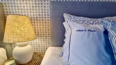 a bed with a blue and white pillow and a lamp at Adam's Place (Garça Real)CD242 - Clever Details, Sleeps 4 people, Wifi, Garage in Vilamoura