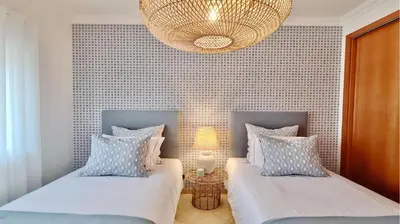 a bedroom with two beds and a chandelier at Adam's Place (Garça Real)CD242 - Clever Details, Sleeps 4 people, Wifi, Garage in Vilamoura
