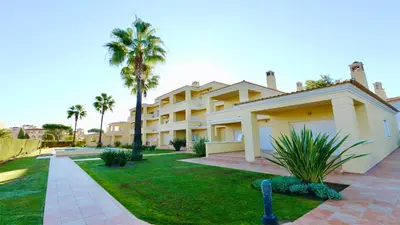 a large house with palm trees and a lawn at Adam's Place (Garça Real)CD242 - Clever Details, Sleeps 4 people, Wifi, Garage in Vilamoura