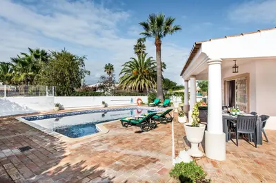 a backyard with a swimming pool and a house at Celina by Algarve Villa Holidays in Guia