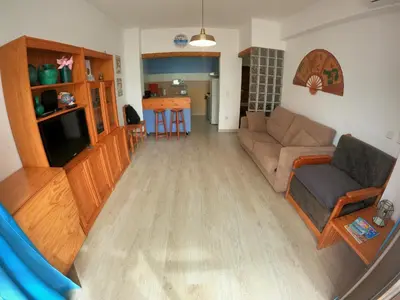 a living room with a couch and a tv at Algarve, modern T1 apartment with balcony, Quarteira in Quarteira