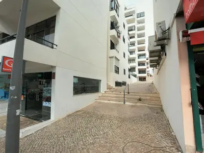 an empty street in front of a building at Algarve, modern T1 apartment with balcony, Quarteira in Quarteira