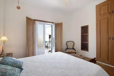 a bedroom with a large white bed and a window at Casa da Cidade de Loulé in Loulé