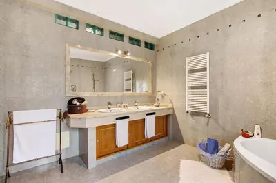 a bathroom with a sink and a mirror and a tub at Casa da Cidade de Loulé in Loulé