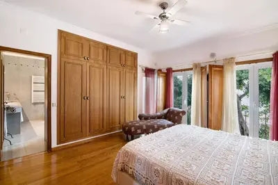 a bedroom with a bed and a chair at Casa da Cidade de Loulé in Loulé