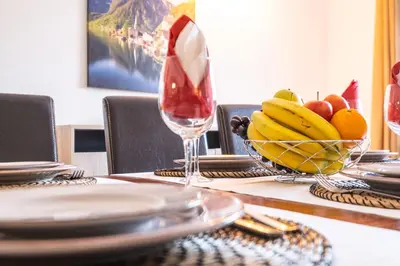 a table with a bowl of fruit and a wine glass at Villa Canguu by Algarve Vacation in Albufeira