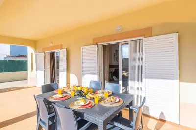 a dining room with a table and chairs at Villa Canguu by Algarve Vacation in Albufeira
