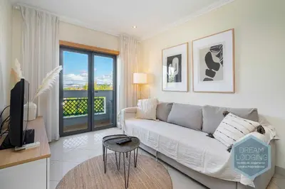 a living room with a couch and a television at Quinta do Pinheiro Residence AN - Dream Lodging in Albufeira