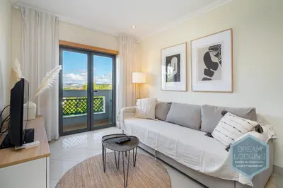 a living room with a couch and a tv at Quinta do Pinheiro Residence AN - Dream Lodging in Albufeira