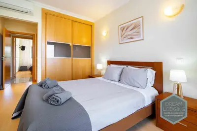 a bedroom with a bed with towels on it at Quinta do Pinheiro Residence AN - Dream Lodging in Albufeira