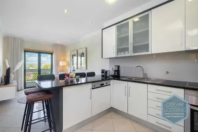a kitchen with white cabinets and a counter top at Quinta do Pinheiro Residence AN - Dream Lodging in Albufeira