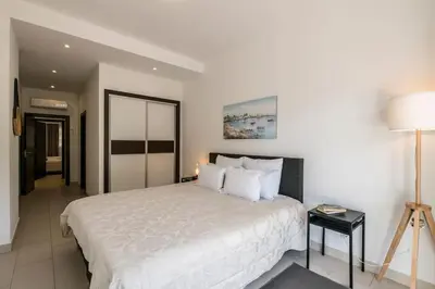 a bedroom with a large white bed and a lamp at Albufeira Old Town Center - VERASOL 2 in Albufeira
