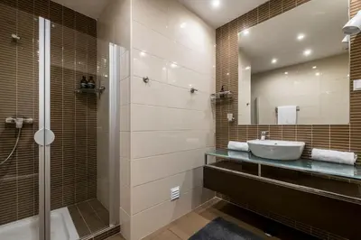 a bathroom with a sink and a shower and a mirror at Albufeira Old Town Center - VERASOL 2 in Albufeira