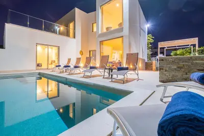 a villa with a swimming pool at night at Villa Laura by Algarve Vacation in Albufeira
