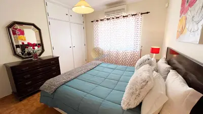 a bedroom with a bed and a dresser and a mirror at Villa Gilsónia by Sunny Deluxe in Guia