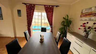 a dining room with a table and chairs and a window at Villa Gilsónia by Sunny Deluxe in Guia