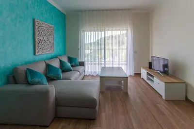 a living room with a couch and a television at Apartment Aria - Great area for children in Albufeira