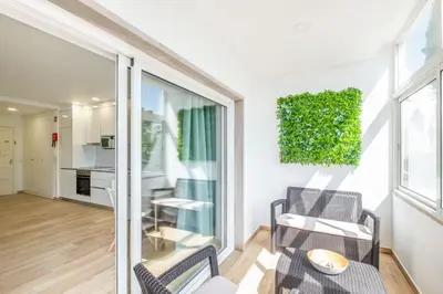 a living room with two chairs and a table at Studio Pimenta - Short walk to the beach in Albufeira