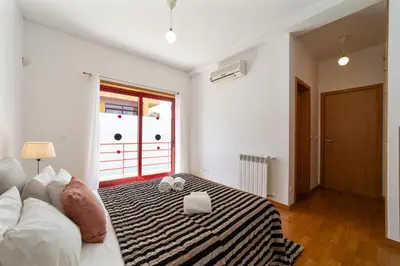 a living room with a bed and a window at Villa Marina in Albufeira