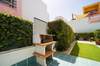 a wooden bench sitting on the side of a building at Villa Marina in Albufeira