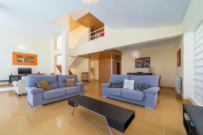 a living room with two blue couches and a table at Villa Marina in Albufeira