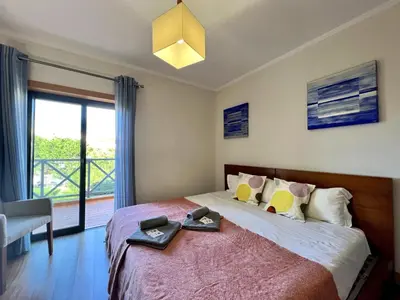 a bedroom with a bed with a large window at Albufeira Modern 3 With Pool by Homing in Albufeira