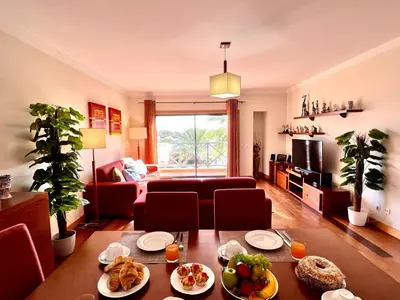 a living room with a table with food on it at Albufeira Modern 3 With Pool by Homing in Albufeira