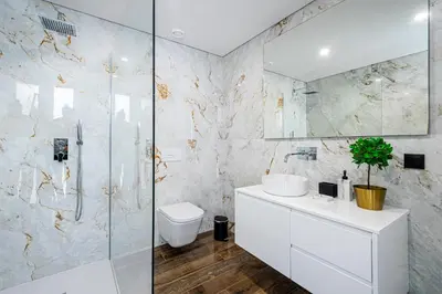 a bathroom with a shower and a toilet and a sink at BeGuest Albufeira Luxus Villa in Albufeira
