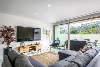 a living room with a couch and a tv at BeGuest Albufeira Luxus Villa in Albufeira